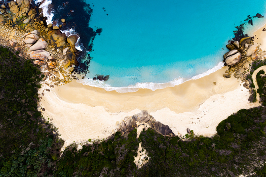 Aerial view of Bettys Beach with turquoise water white sand and surrounding rock formations in Albany WA Australia. Aerial view of Bettys Beach with turquoise water white sand and surrounding rock formations in Albany WA Australia.