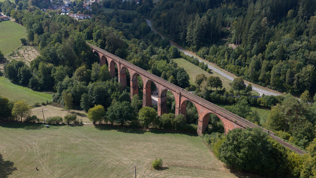 Aerial view of the historic Himbaechel Viaduct surrounded by lush green forests and meadows in Erbach Hessen Germany. Aerial view of the historic Himbaechel Viaduct surrounded by lush green forests and meadows in Erbach Hessen Germany.