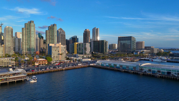 Aerial view of the San Diego skyline and waterfront along North Harbor Drive and North Embarcadero with modern skyscrapers and harbor piers in San Diego California United States.