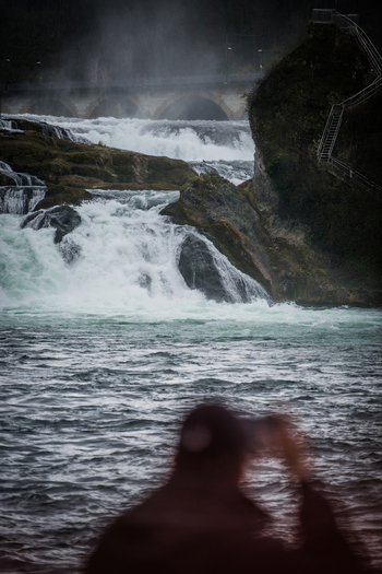 View of the powerful Rhine Falls cascading over rocks with mist rising and an ethereal feel Neuhausen am Rheinfall Schaffhausen Switzerland. View of the powerful Rhine Falls cascading over rocks with mist rising and an ethereal feel Neuhausen am Rheinfall Schaffhausen Switzerland.
