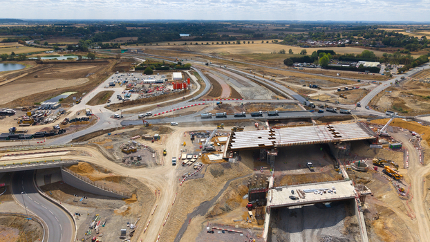 Aerial view of the Black Cat Roundabout highway construction site featuring bridge beams heavy machinery and road infrastructure development in Chawston England United Kingdom. Aerial view of the Black Cat Roundabout highway construction site featuring bridge beams heavy machinery and road infrastructure development in Chawston England United Kingdom.
