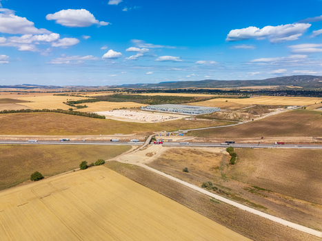 Aerial view of roadworks near Paty Hungary by warehouses and fields. Aerial view of roadworks near Paty Hungary by warehouses and fields.