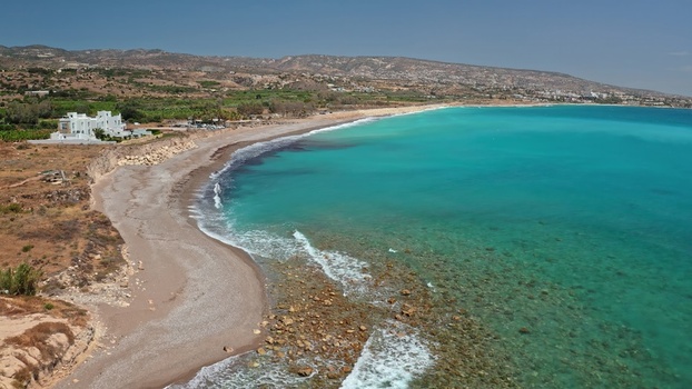 Aerial view of the turquoise Mediterranean coastline with a sandy beach rocky cliffs and a white villa overlooking the sea in Cyprus Cyprus. Aerial view of the turquoise Mediterranean coastline with a sandy beach rocky cliffs and a white villa overlooking the sea in Cyprus Cyprus.