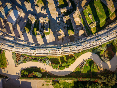 Aerial view of the Pula Arena stands proudly a testament to ancient history its stone walls casting long shadows across the green grass Pula Istria County Croatia.