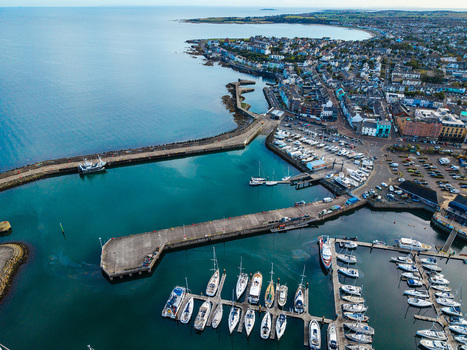 Aerial view of Bangor Harbour and Town featuring a marina filled with boats historic buildings and the coastline in Bangor Northern Ireland United Kingdom.