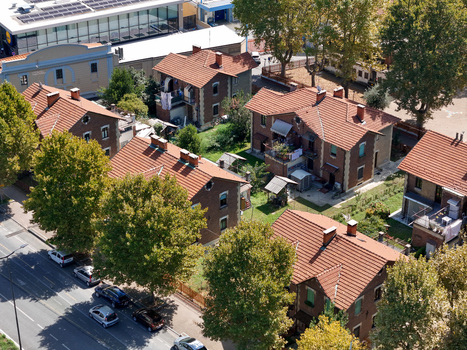 Aerial view of the historic Villaggio Leumann worker houses with red tiled roofs and green trees in Collegno Piemonte Italy. Aerial view of the historic Villaggio Leumann worker houses with red tiled roofs and green trees in Collegno Piemonte Italy.