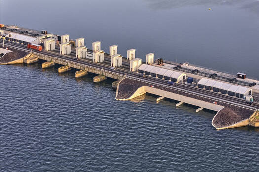 Den Oever Noord Holland Netherlands 19 June 2026 Aerial view of the Stevinsluizen sluice dam under renewal featuring newly built fish friendly pumping stations in the early morning light. Den Oever Noord Holland Netherlands 19 June 2026 Aerial view of the Stevinsluizen sluice dam under renewal featuring newly built fish friendly pumping stations in the early morning light.