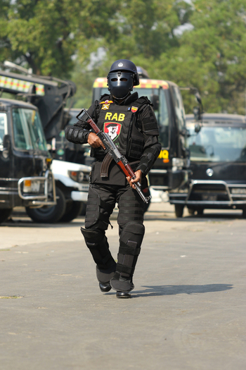 Dhaka Bangladesh 08 January 2017 View of a member of the Rapid Action Battalion RAB in full tactical gear and face shield holding a rifle at the RAB Headquarters. Dhaka Bangladesh 08 January 2017 View of a member of the Rapid Action Battalion RAB in full tactical gear and face shield holding a rifle at the RAB Headquarters.