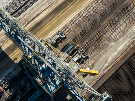 Aerial view of Tagebau Welzow Sud brown coal open pit mine with massive industrial machinery and railway tracks in Spremberg Brandenburg Germany. Aerial view of Tagebau Welzow Sud brown coal open pit mine with massive industrial machinery and railway tracks in Spremberg Brandenburg Germany.