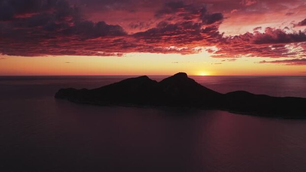 Aerial view of Sa Dragonera island silhouette at sunset Spain.