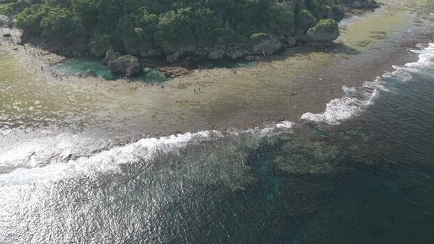 Aerial view of the rocky coastline of Siargao Island Philippines.