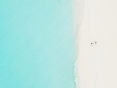 Aerial view of the cerulean sea gently kissing the pristine white sandy beach Vashafaru Island Thiladhummathi Atoll Maldives. Aerial view of the cerulean sea gently kissing the pristine white sandy beach Vashafaru Island Thiladhummathi Atoll Maldives.