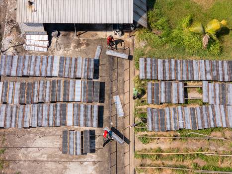 Aerial view of UKM Sohun showing workers drying noodle sheets on wooden racks in a production area in Kecamatan Tulung Jawa Tengah Indonesia.
