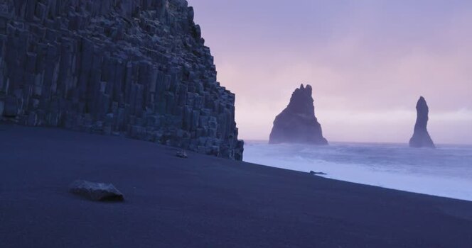 View of basalt columns and sea stacks at Reynisfjara Iceland. View of basalt columns and sea stacks at Reynisfjara Iceland.