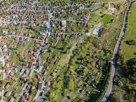Aerial view of Valaska Dubova village with its traditional red roofed houses lush gardens and surrounding green fields in Valaska Dubova Zilina Region Slovakia. Aerial view of Valaska Dubova village with its traditional red roofed houses lush gardens and surrounding green fields in Valaska Dubova Zilina Region Slovakia.