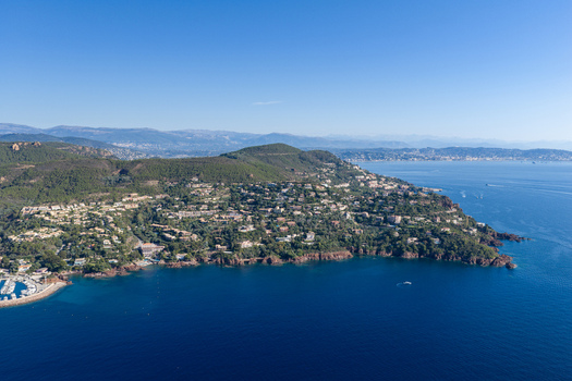 Aerial view of Le Trayas coastal landscape with lush green hills residential villas and rocky cliffs overlooking the Mediterranean Sea in Saint Raphael Provence Alpes Cote d Azur France. Aerial view of Le Trayas coastal landscape with lush green hills residential villas and rocky cliffs overlooking the Mediterranean Sea in Saint Raphael Provence Alpes Cote d Azur France.