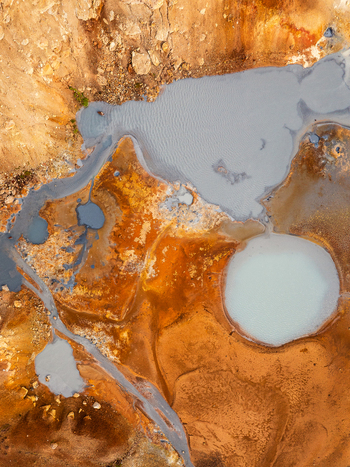 Aerial view of geothermal landscape with vibrant mineral deposits and milky blue pools in the rugged terrain of Iceland. Aerial view of geothermal landscape with vibrant mineral deposits and milky blue pools in the rugged terrain of Iceland.