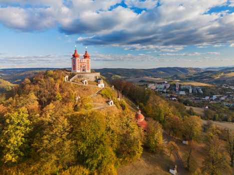 Aerial view of the historic Stiavnicka Kalvaria pilgrimage site with red roofed church and winding paths amidst autumn forest in Banska Stiavnica Banskobystricky kraj Slovakia. Aerial view of the historic Stiavnicka Kalvaria pilgrimage site with red roofed church and winding paths amidst autumn forest in Banska Stiavnica Banskobystricky kraj Slovakia.