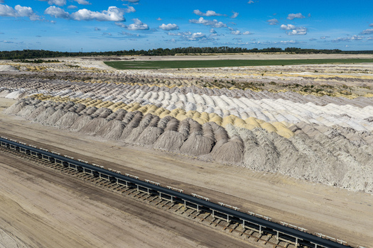 Aerial view of Tagebau Welzow Sud brown coal open pit mine with long conveyor belt systems and vast piles of excavated earth in the industrial landscape of Spremberg Brandenburg Germany. Aerial view of Tagebau Welzow Sud brown coal open pit mine with long conveyor belt systems and vast piles of excavated earth in the industrial landscape of Spremberg Brandenburg Germany.
