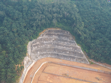 Aerial view of slope stabilization anchoring with terraced concrete walls and soil reinforcement systems situated amidst dense palm oil plantations in Bukit Mertajam Penang Malaysia. Aerial view of slope stabilization anchoring with terraced concrete walls and soil reinforcement systems situated amidst dense palm oil plantations in Bukit Mertajam Penang Malaysia.