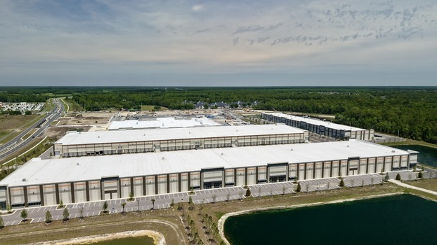 Aerial view of large industrial warehouses and distribution centers surrounded by green forests and ponds near Saint Johns Parkway in World Golf Village Florida United States. Aerial view of large industrial warehouses and distribution centers surrounded by green forests and ponds near Saint Johns Parkway in World Golf Village Florida United States.