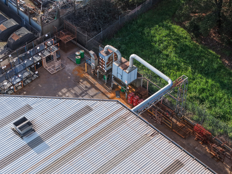 Aerial view of industrial factory facilities with corrugated metal roofing ventilation ducts and storage racks in Kilsyth South Melbourne VIC Australia. Aerial view of industrial factory facilities with corrugated metal roofing ventilation ducts and storage racks in Kilsyth South Melbourne VIC Australia.
