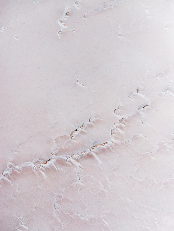 Aerial view of abstract minimal pink salt lake textures and pastel colours on Lake Lefroy Western Australia
