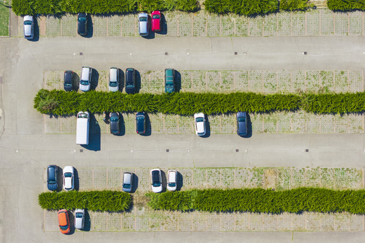 Aerial view of a parking lot with rows of parked cars separated by green hedges in Arezzo Tuscany Italy. Aerial view of a parking lot with rows of parked cars separated by green hedges in Arezzo Tuscany Italy.