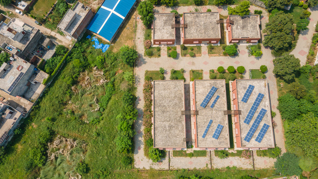 Lahore Punjab Pakistan 08 September 2026 Aerial view of Government Officers residences with rooftop solar panels data canter lush gardens and paved walkways in a suburban neighborhood.