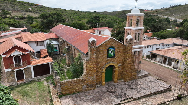 Torotoro Potosi Department Bolivia 29 September 2026 Aerial view of the historic stone church with a bell tower and red tiled roof surrounded by village buildings and hills.