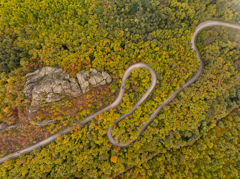 Aerial view of the winding road through the autumn forest and the unique rock formations of Belogradchik Vidin Bulgaria. Aerial view of the winding road through the autumn forest and the unique rock formations of Belogradchik Vidin Bulgaria.