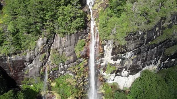 Aerial view of waterfall cascading down rocky cliffs Chile. Aerial view of waterfall cascading down rocky cliffs Chile.
