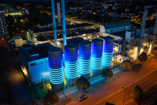 Aerial view of the BTB Heat and Power Plant Adlershof in Berlin with industrial tanks illuminated by blue light to visualize stored heat energy Berlin Berlin Germany. Aerial view of the BTB Heat and Power Plant Adlershof in Berlin with industrial tanks illuminated by blue light to visualize stored heat energy Berlin Berlin Germany.
