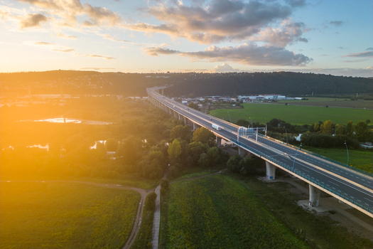 Aerial view of Lahovice Bridge spanning the landscape during golden hour with lush greenery and a clear road in Prague Prague Czechia. Aerial view of Lahovice Bridge spanning the landscape during golden hour with lush greenery and a clear road in Prague Prague Czechia.
