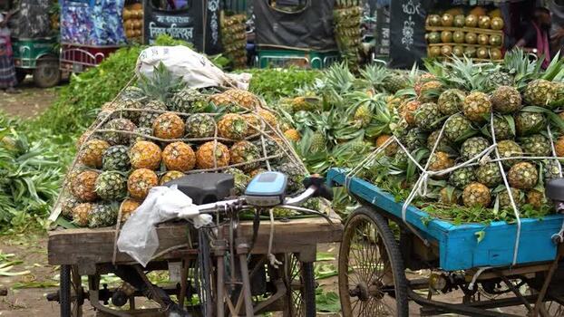 View of pineapples stacked on carts at a market in Bangladesh. View of pineapples stacked on carts at a market in Bangladesh.