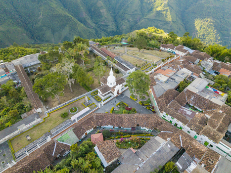 Aerial view of the Immaculate Conception Archdiocesan Sanctuary standing tall with its white facade against a backdrop of lush green hills Salamina Caldas Colombia. Aerial view of the Immaculate Conception Archdiocesan Sanctuary standing tall with its white facade against a backdrop of lush green hills Salamina Caldas Colombia.