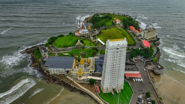 Aerial view of Murudeshwar Temple featuring the towering gopuram and the massive Shiva statue on the coast of the Arabian Sea in Murdeshwar Karnataka India.
