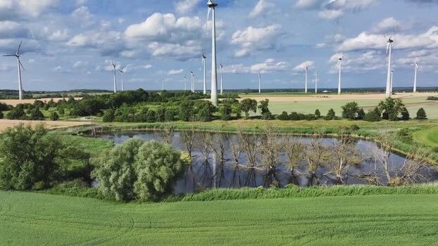 Aerial view of wind turbines and a pond Germany.