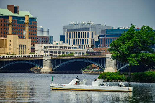 Boston Massachusetts United States 13 June 2025 View of the Charles River with a small white motorboat floating on the water featuring the urban skyline and a bridge in the background. Boston Massachusetts United States 13 June 2025 View of the Charles River with a small white motorboat floating on the water featuring the urban skyline and a bridge in the background.