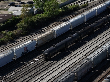 Aerial view of freight trains with tanker and hopper cars on parallel tracks in a rail yard Cincinnati OH United States. Aerial view of freight trains with tanker and hopper cars on parallel tracks in a rail yard Cincinnati OH United States.