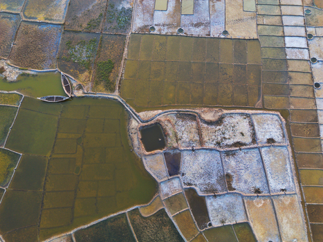 Aerial view of traditional salt pans with rectangular plots and wooden boats in Moheskhali Upazila Chittagong Division Bangladesh. Aerial view of traditional salt pans with rectangular plots and wooden boats in Moheskhali Upazila Chittagong Division Bangladesh.