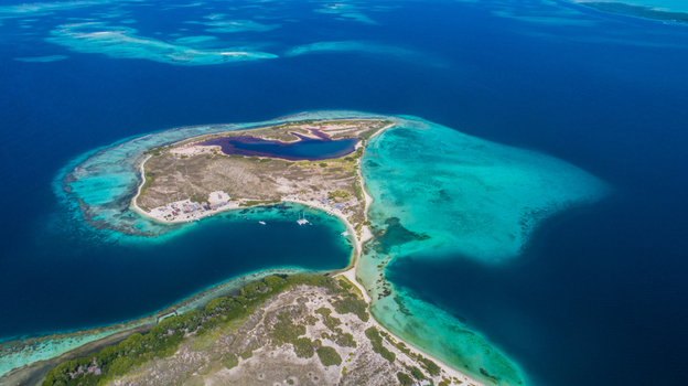 Aerial view of Los Roques archipelago featuring turquoise waters coral reefs and sandy beaches surrounded by the deep blue Caribbean Sea Los Roques Dependencias Federale Venezuela. Aerial view of Los Roques archipelago featuring turquoise waters coral reefs and sandy beaches surrounded by the deep blue Caribbean Sea Los Roques Dependencias Federale Venezuela.