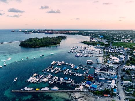 Aerial view of Club Nautico de Santo Domingo Inc. with numerous yachts and boats docked in the marina turquoise water and coastal landscape in Andres Santo Domingo Dominican Republic. Aerial view of Club Nautico de Santo Domingo Inc. with numerous yachts and boats docked in the marina turquoise water and coastal landscape in Andres Santo Domingo Dominican Republic.