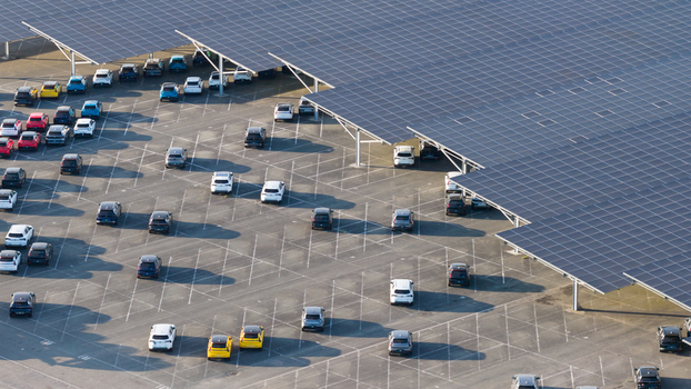 Lambres lez Douai Hauts de France France 07 July 2026 Aerial view of the AESC France facility featuring extensive solar panel carports covering a large parking lot filled with numerous cars.
