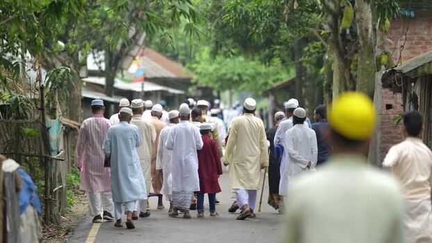 View of Muslim men walking on a village road in Bangladesh. View of Muslim men walking on a village road in Bangladesh.