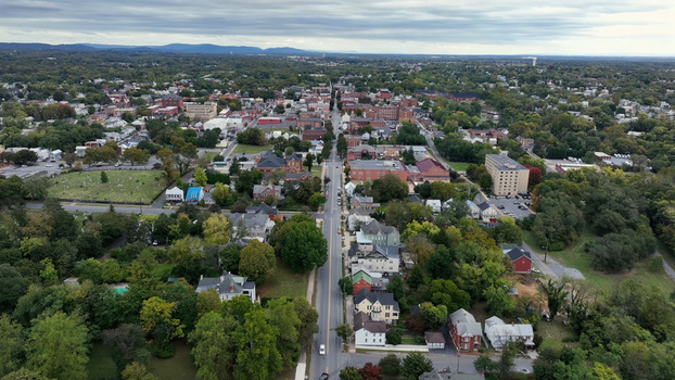 Aerial view of the historic town of Martinsburg with its grid of streets residential houses and lush green trees under a cloudy sky in Martinsburg West Virginia United States.