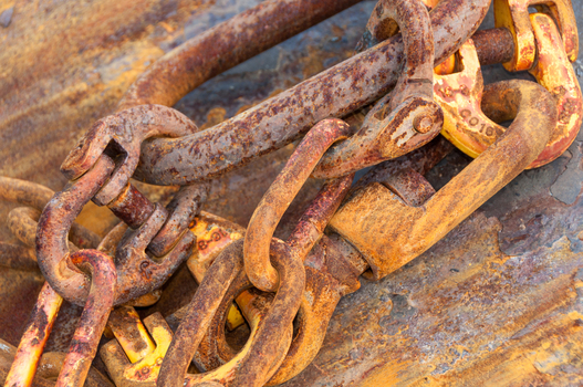 View of rusty metal chains and heavy duty hooks used in fishing equipment in Canada. View of rusty metal chains and heavy duty hooks used in fishing equipment in Canada.