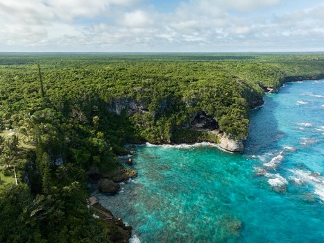 Aerial view of the vibrant turquoise sea meeting the rugged verdant cliffs of the coastline a tropical paradise from above Joking Lifou New Caledonia. Aerial view of the vibrant turquoise sea meeting the rugged verdant cliffs of the coastline a tropical paradise from above Joking Lifou New Caledonia.