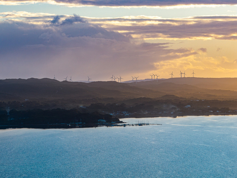 Aerial view of Camp Quaranup at sunset with wind turbines on the hills and a calm bay in Vancouver Peninsula Western Australia Australia. Aerial view of Camp Quaranup at sunset with wind turbines on the hills and a calm bay in Vancouver Peninsula Western Australia Australia.