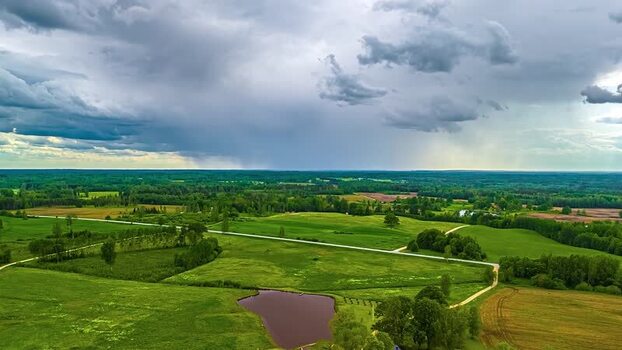Aerial view of green fields and a pond in rural Latvia. Aerial view of green fields and a pond in rural Latvia.